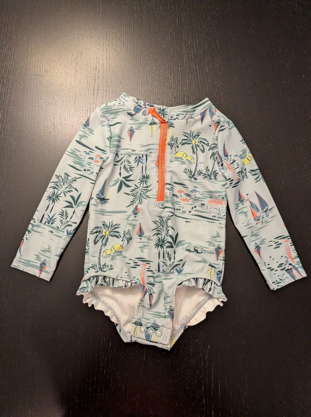 Kids Long-Sleeve One-Piece Rash Guard Swimsuit in Light Teal with Tropical Print